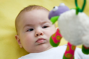 Baby Looking Up At A Mobile Toy